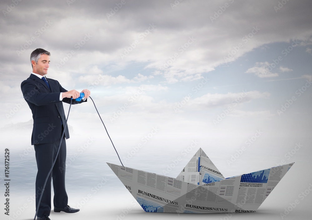 Businessman pulling paper boat