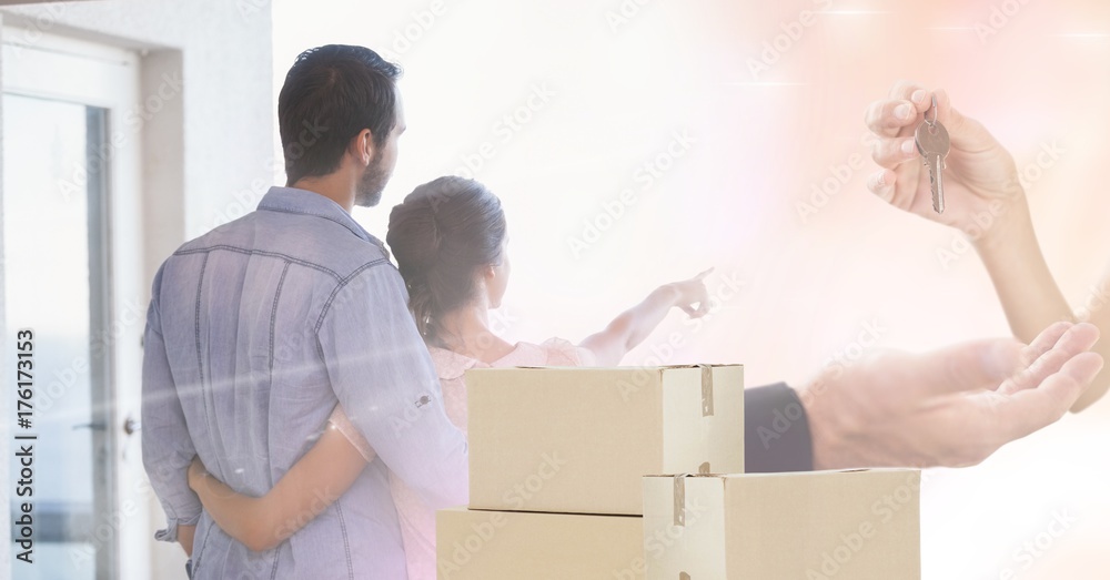 people moving boxes into new home with keys