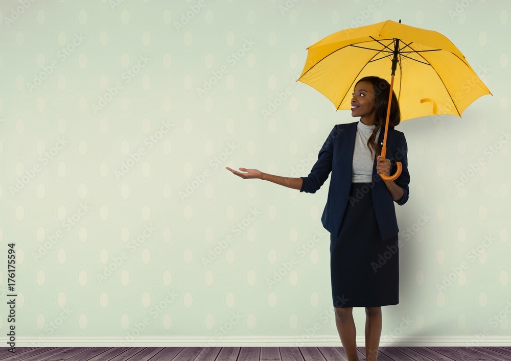 Businesswoman holding umbrella in room