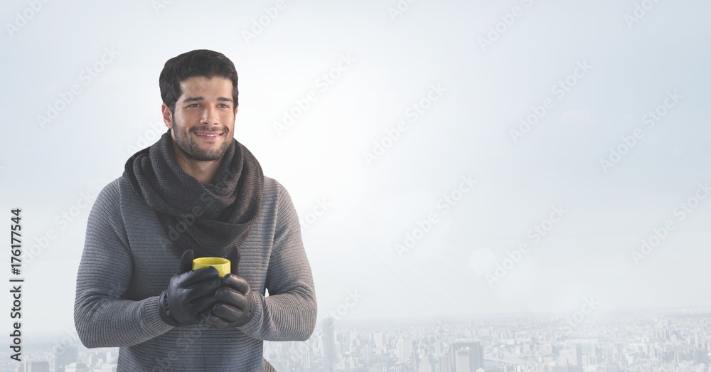 Man with cup over bright city