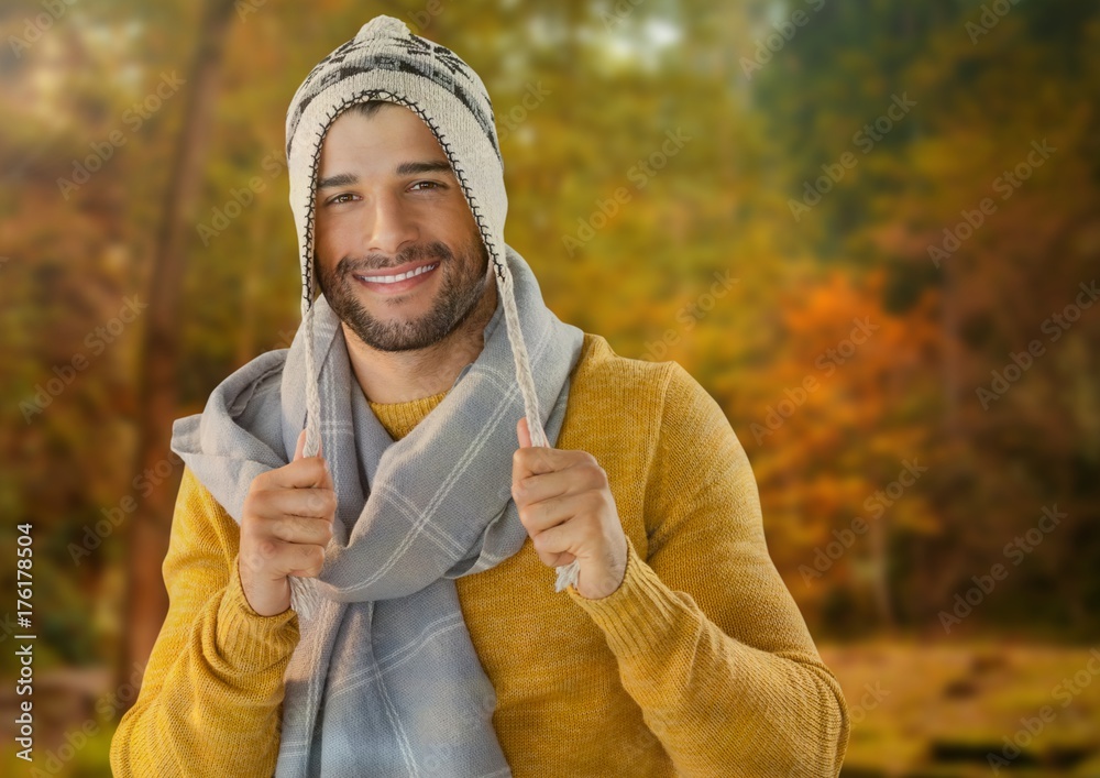 Man in Autumn with hat and scarf in forest