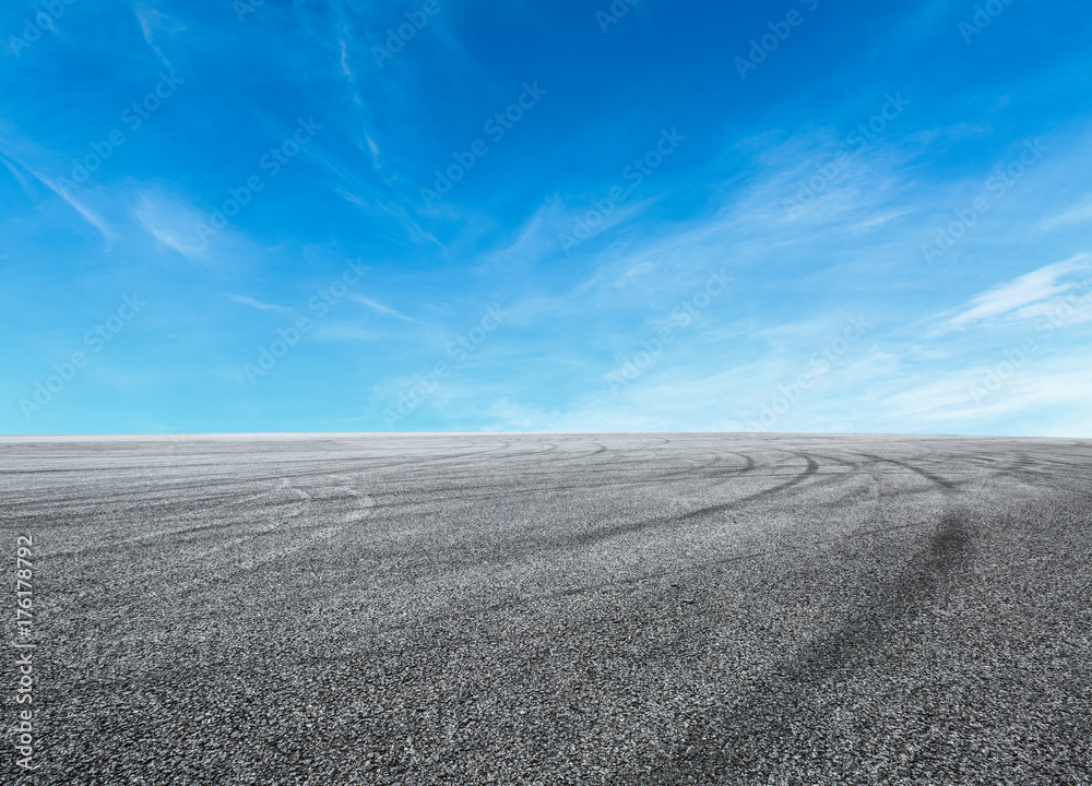 Asphalt road circuit and sky clouds with car tire brake