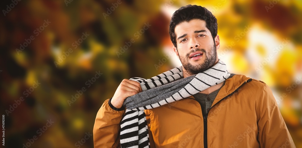 Composite image of portrait of young man wearing scarf posing