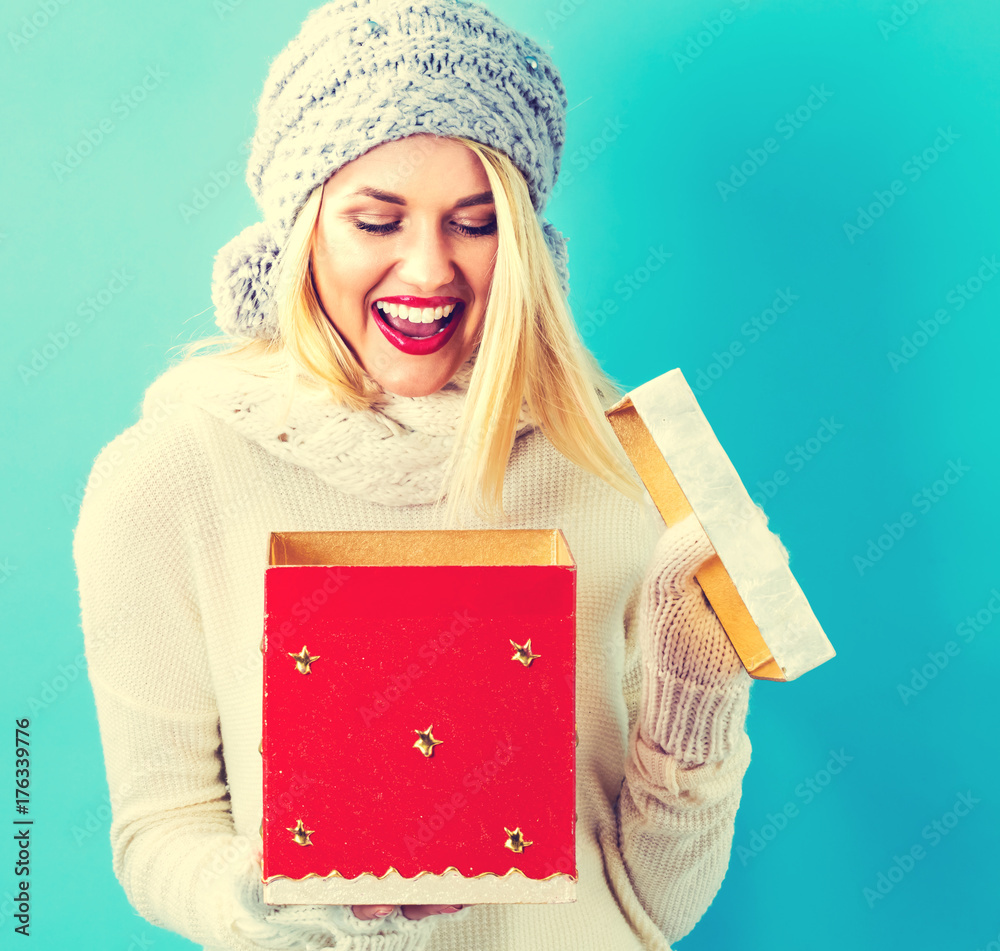 Happy young woman opening a Christmas present box