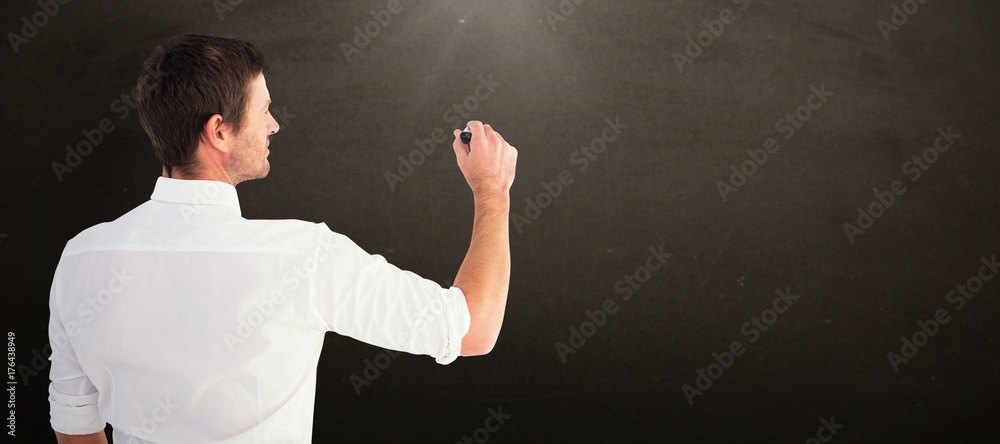 Composite image of business man writing with chalk