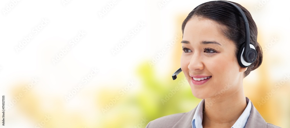 Composite image of happy operator posing with a headset