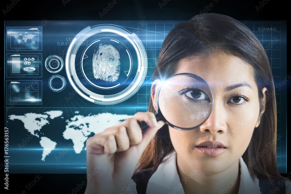 Composite image of businesswoman looking through magnifying