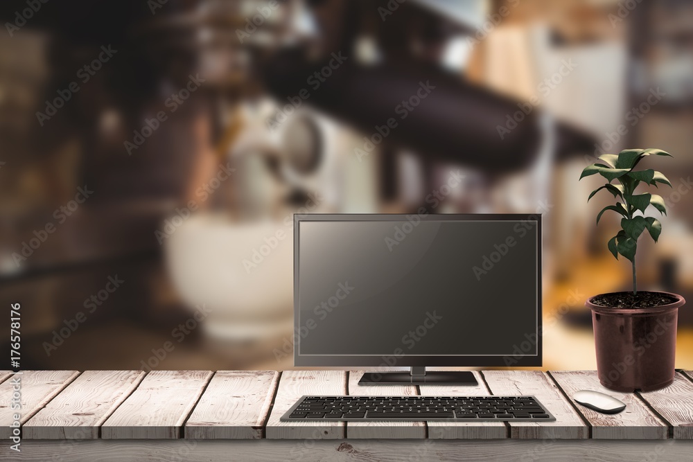 Composite image of a computer over a desk 