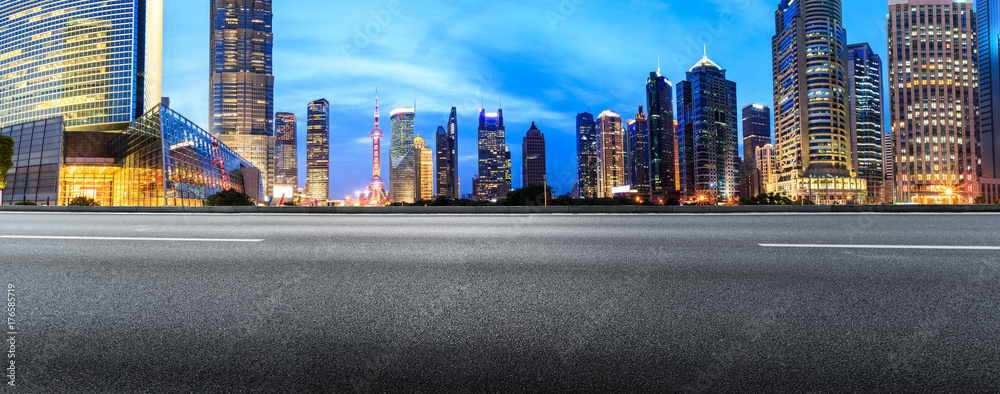 Shanghai Lujiazui financial district commercial building and asphalt road panorama at night,China