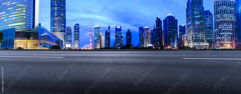 Shanghai Lujiazui financial district commercial building and asphalt road panorama at night,China