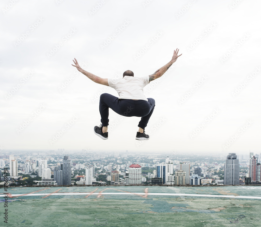 Man jumping on the rooftop