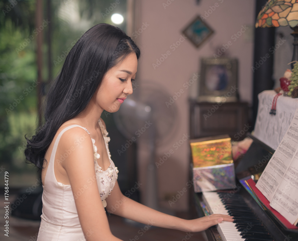 Asian woman playing piano