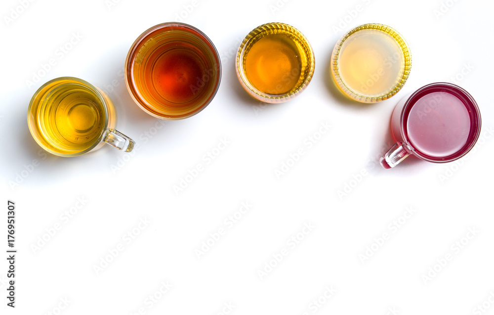 Various herbal tea in glass cups on white