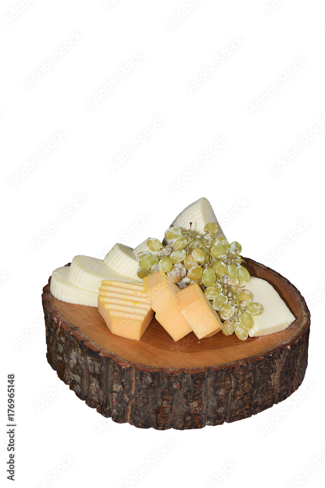 Cheeses of different varieties, decorated with grapes, isolated on white background.