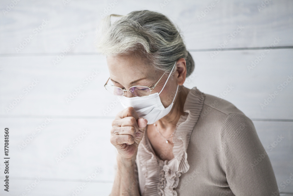 Portrait of an old woman holding a cold