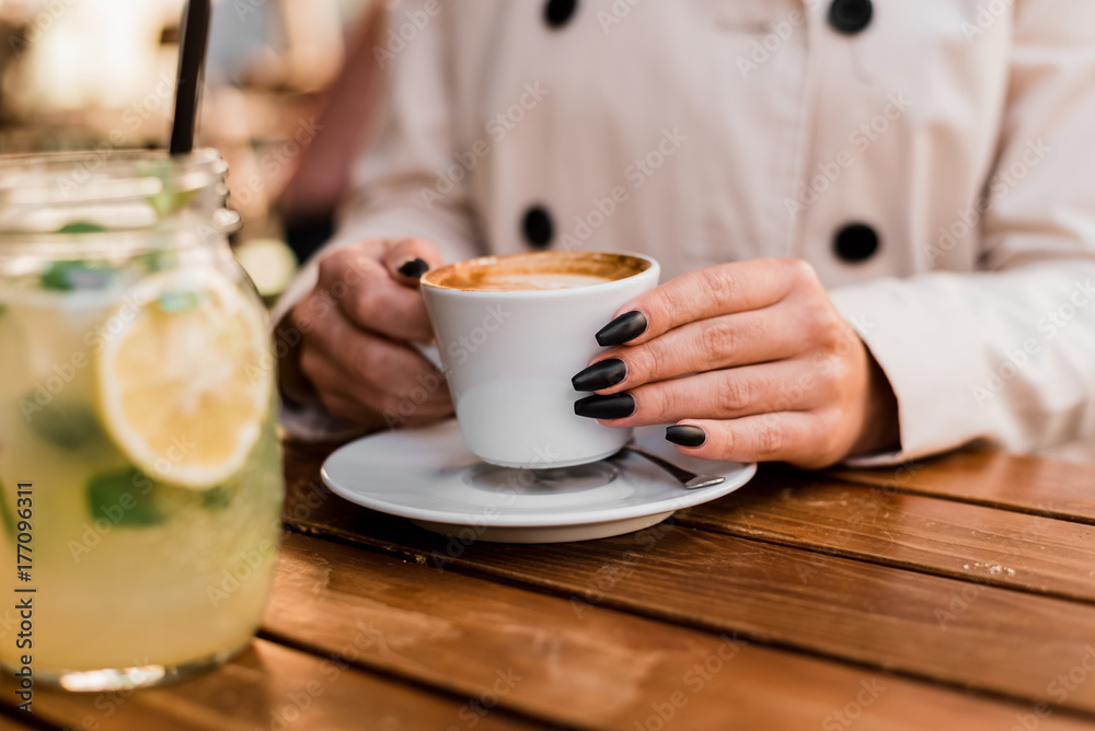 Coffee pause. Girl on the break from work. Hands closeup.