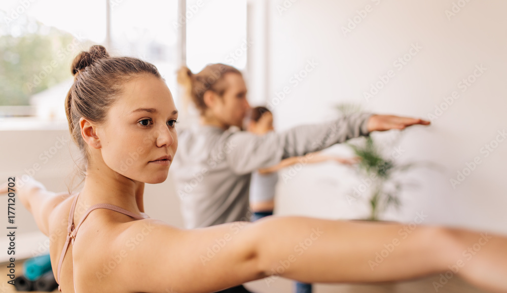 Fitness people doing yoga in gym class