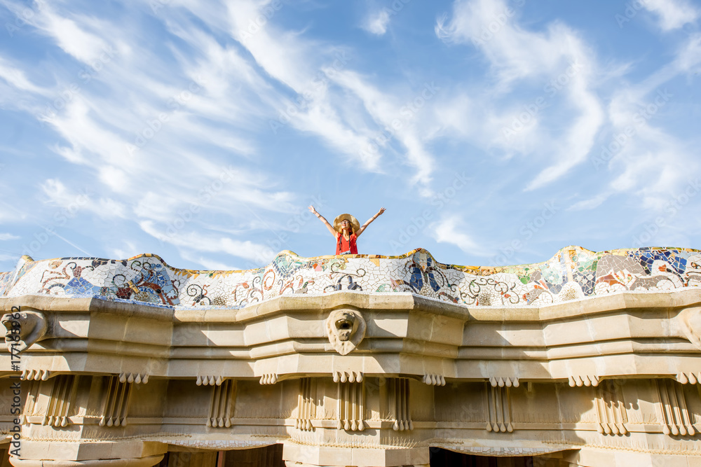 View on the beautiful terrace decorated with mosaic with happy woman tourist in Guell park in Barcel