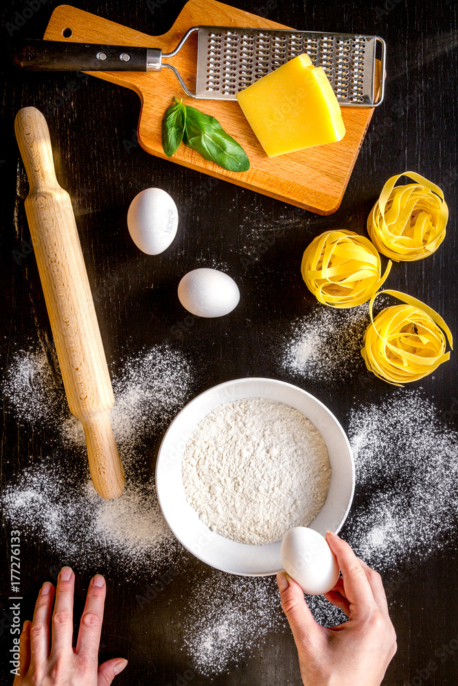 chef cooking pasta top view on dark background