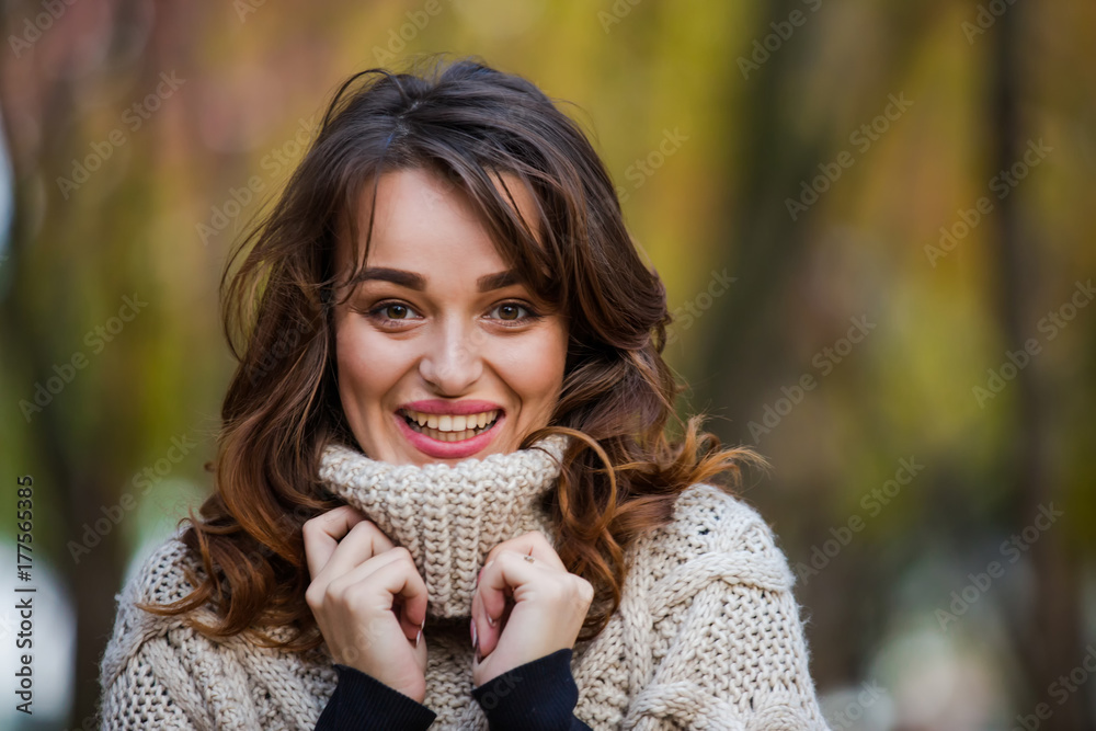 Autumn woman portrait smiling outdoors at the park