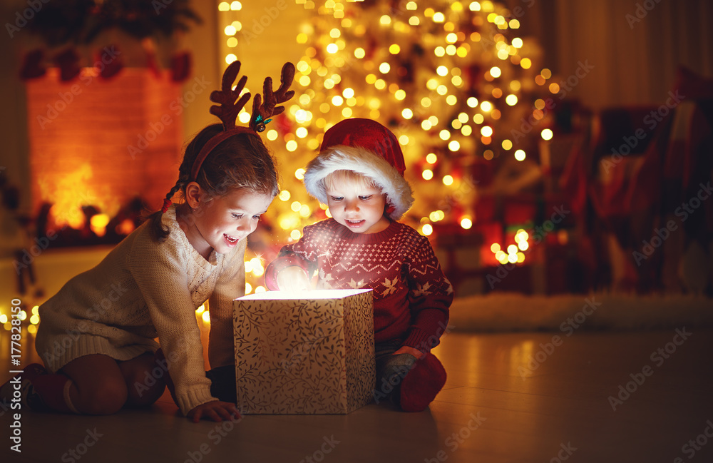 Merry Christmas! happy children with magic  gift  at home