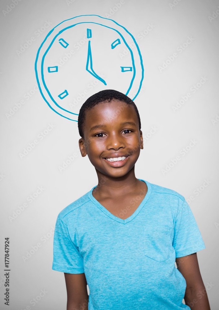 Boy against grey background with blue t-shirt smiling and clock