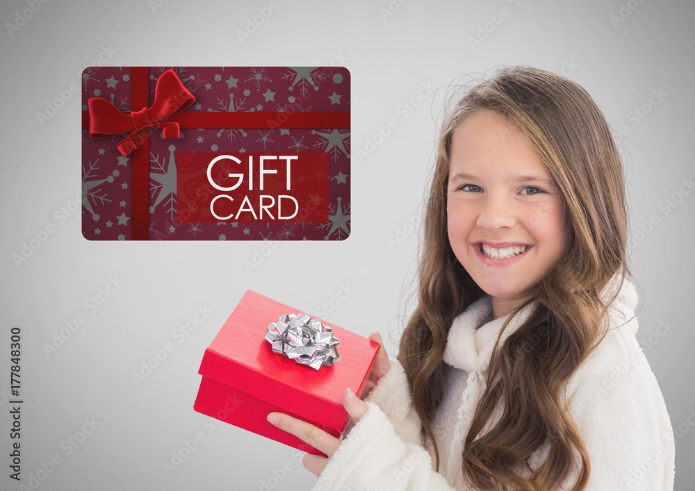 Girl against grey background with Christmas gift and gift card