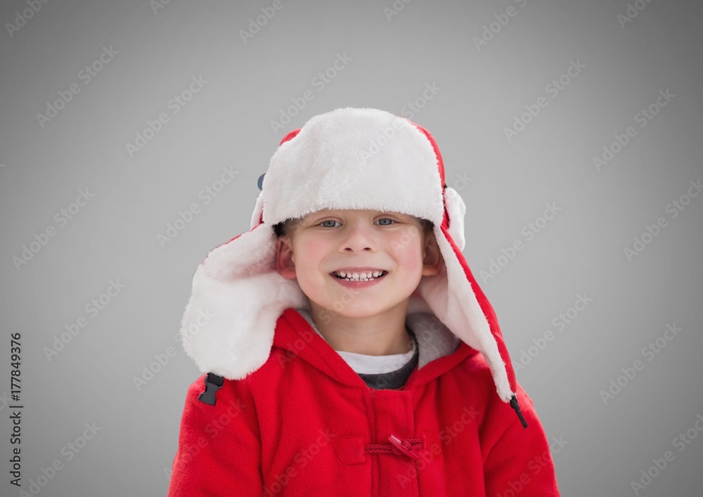 Boy against grey background with Winter Christmas warm clothes