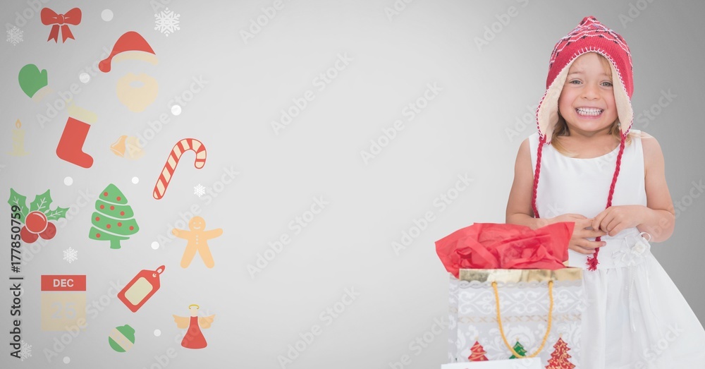 Girl against grey background with Christmas gift bag and