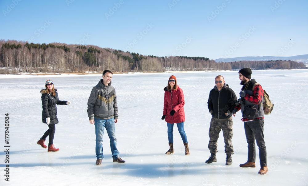 Friends having fun on a frozen lake