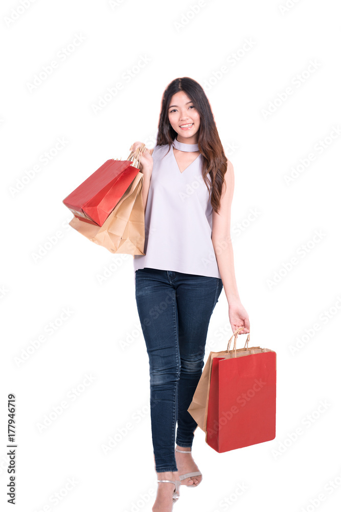 Young Asian woman with shopping packages isolated on white, she carrying shopping bags,full length