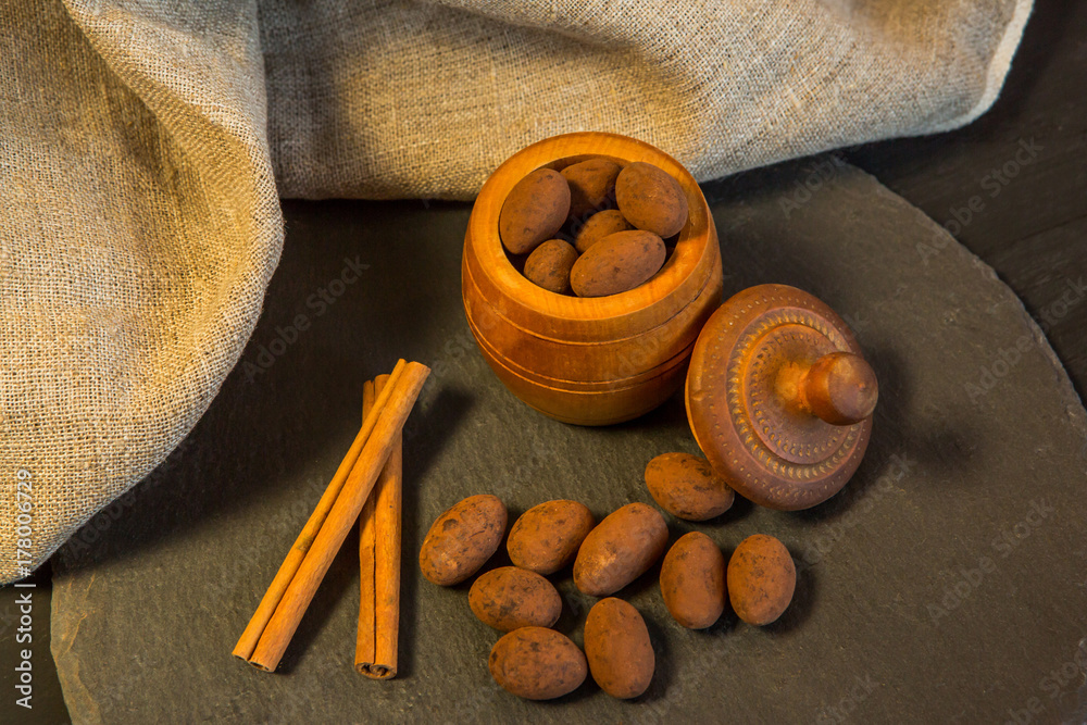 Almond in chocolate. Сchocolate candies with cocoa powder.