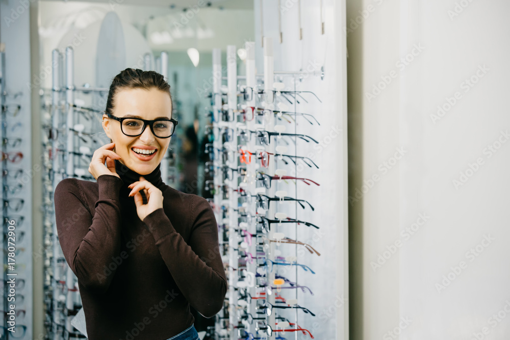 Young girl buys glasses. Optics. Emotions. Оptical store