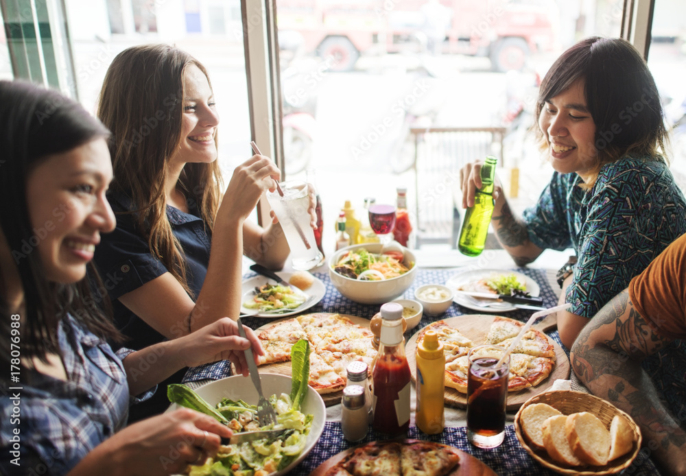 Friends having pizza at a restaurant