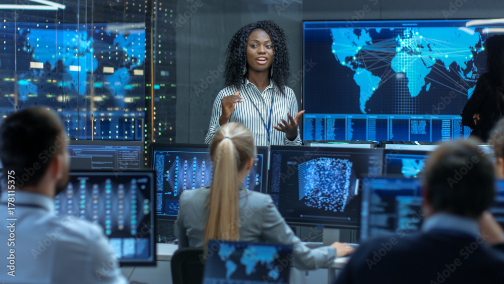 Chief Project Engineer Holds Briefing for a Team of Scientists that are Building Machine Learning Sy