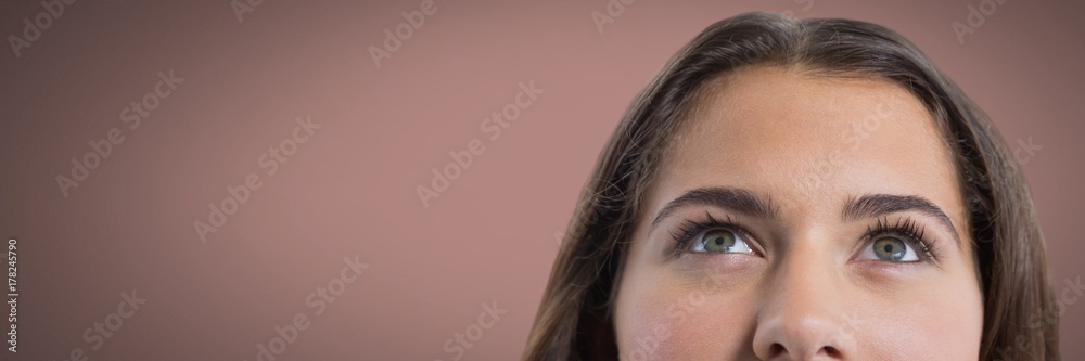 Woman looking up with brown background