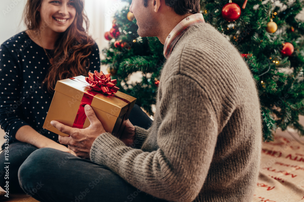 Young couple celebrating Christmas at home.