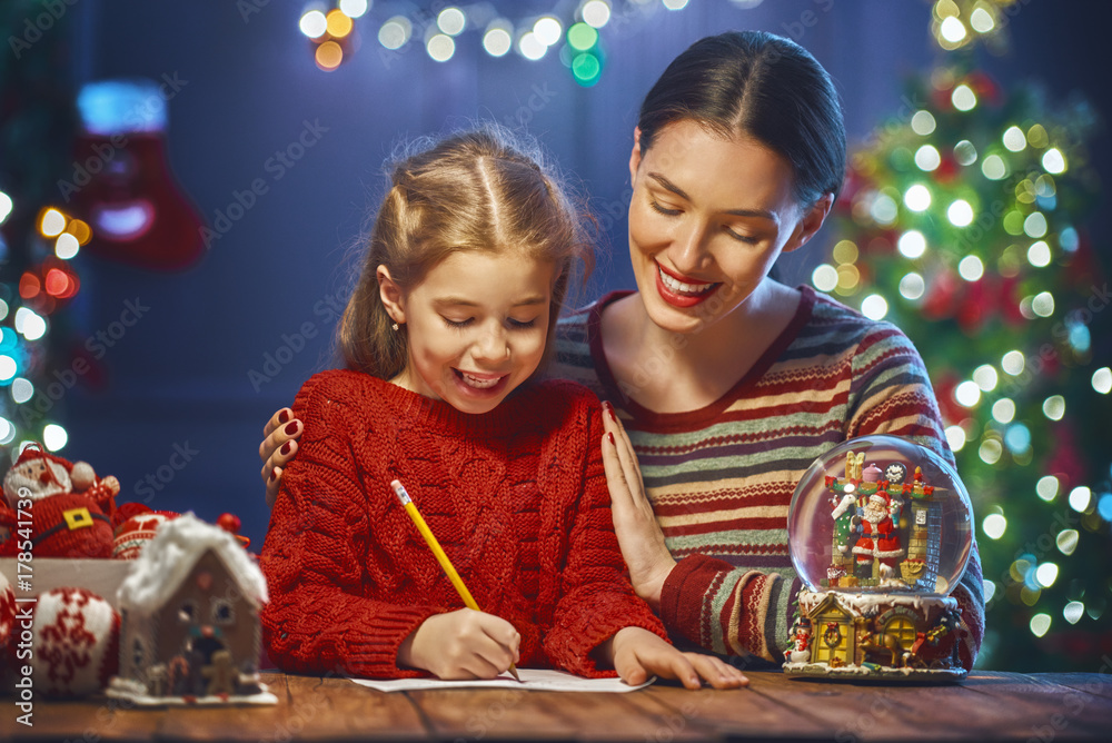 Mom and daughter writing mail to Santa