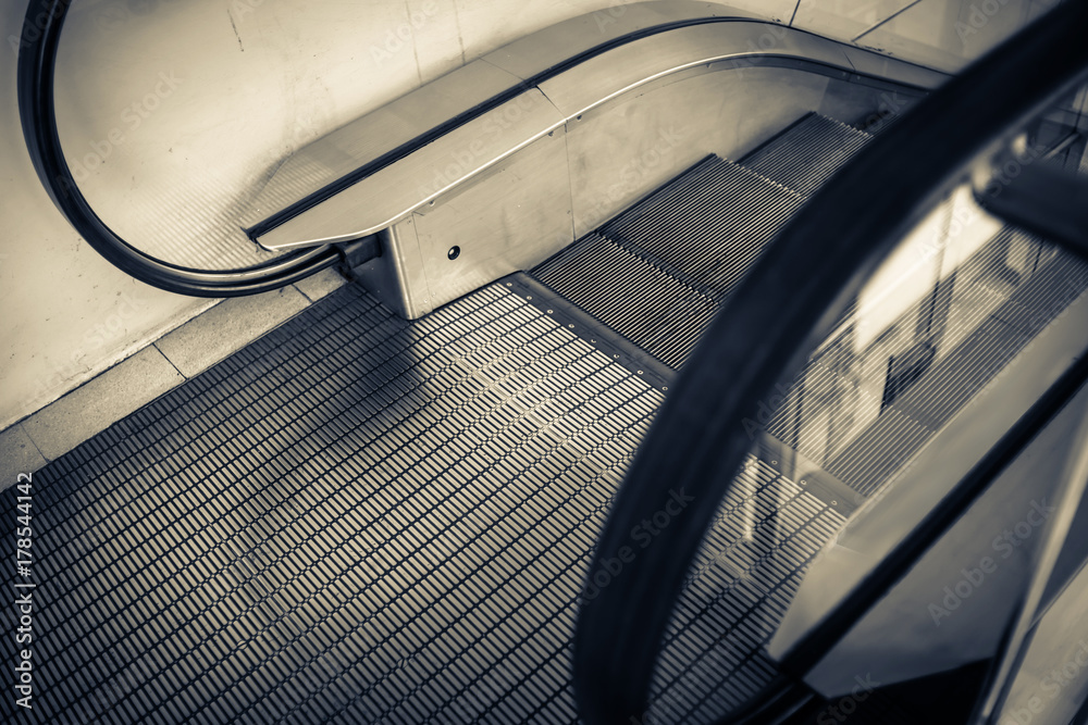 Close up to escalator yellow and gray steel line.