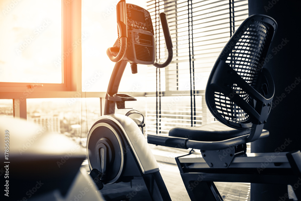 close up treadmill in fitness room background with color tone and light flare effect