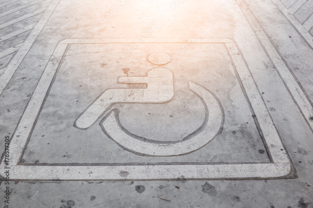 HANDICAP WHEEL CHAIR  SIGN OF PARK SIGNAGE ON PARKING LOT FLOOR