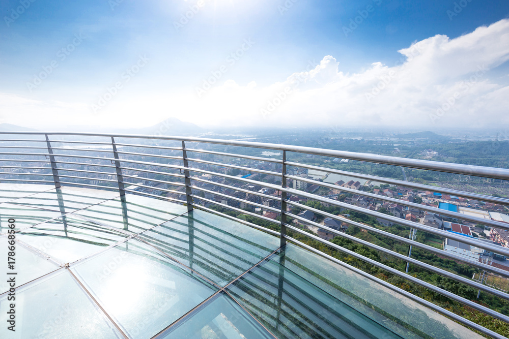 glass pedestrian bridge over hill