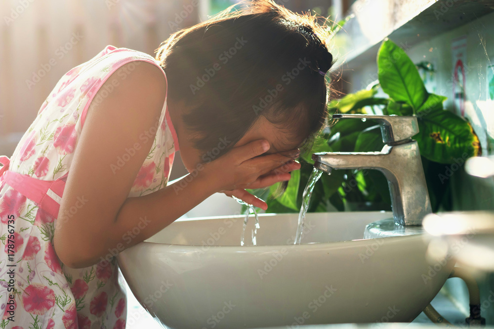 children washing face in basin