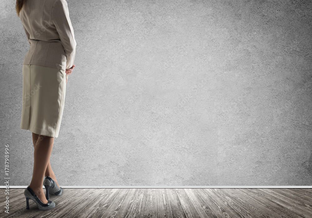 Businesswoman looking at wall