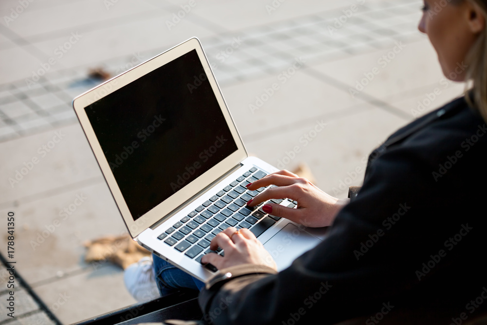 Close up laptop screen, woman using computer outdoor at the city street