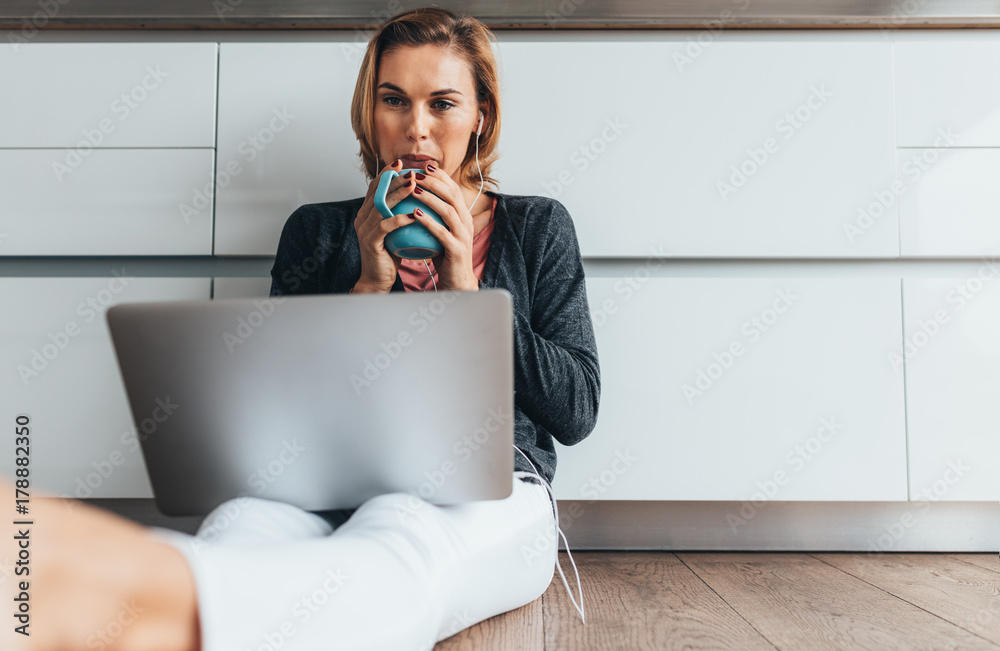 Woman working on laptop computer at home