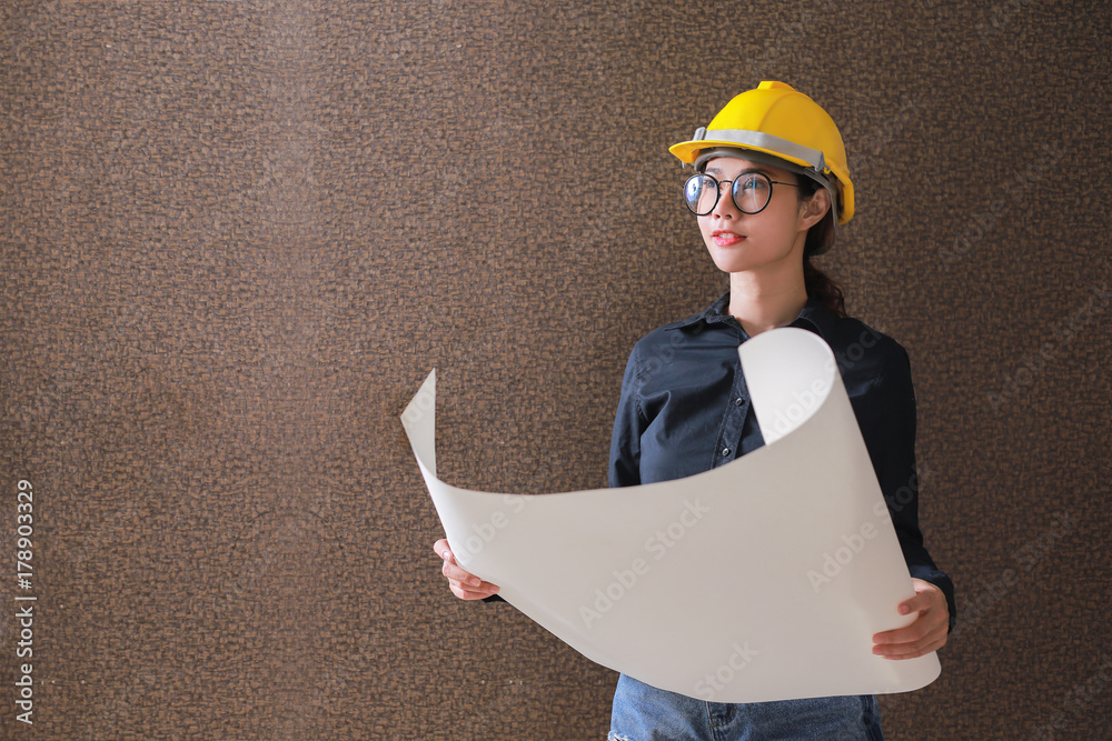 Business woman engineer developer holding blueprint on background.