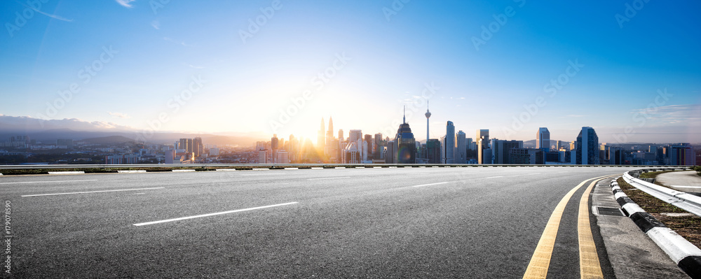 empty asphalt road with modern cityscape