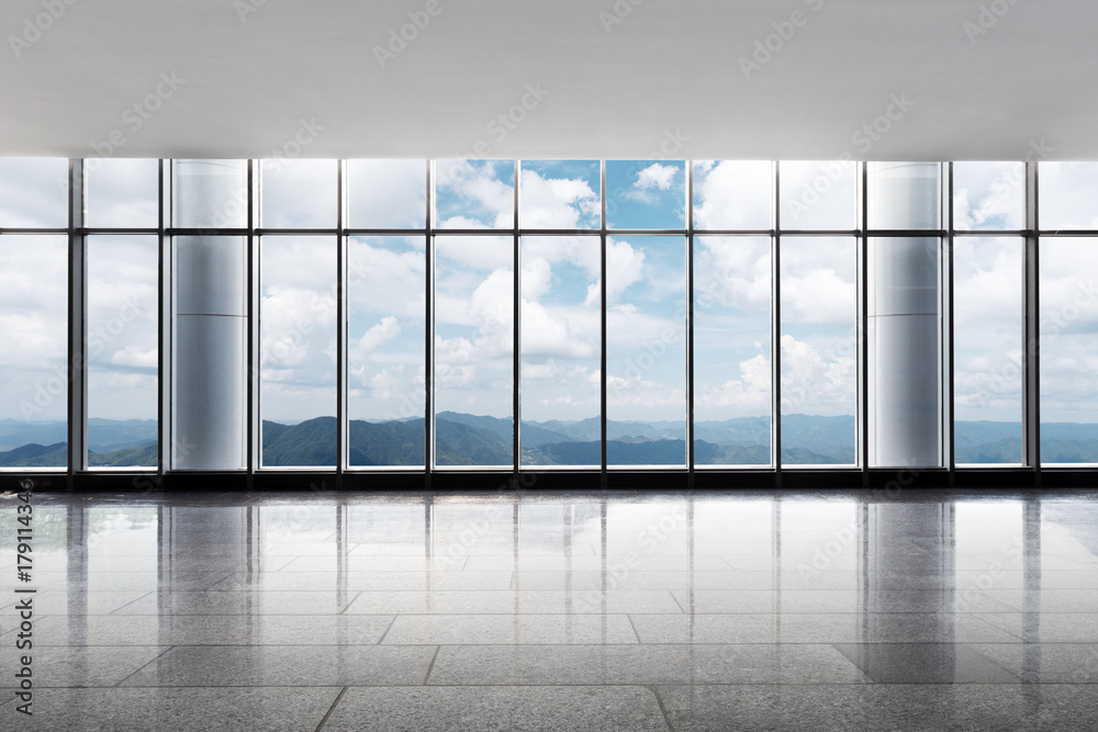 empty office with green hill in cloud sky