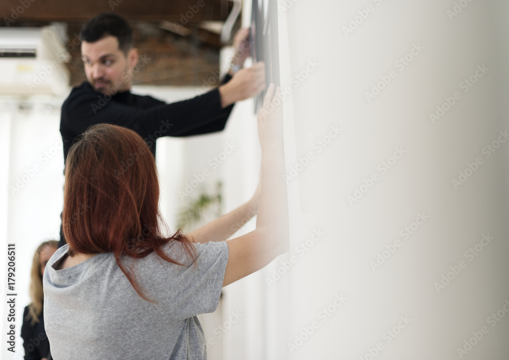 Man taking care of frames in an exhibition